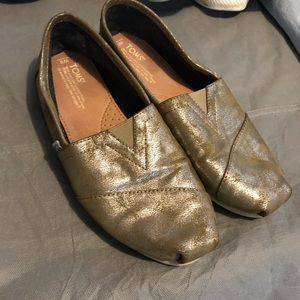Toms iridescent gold slip ons